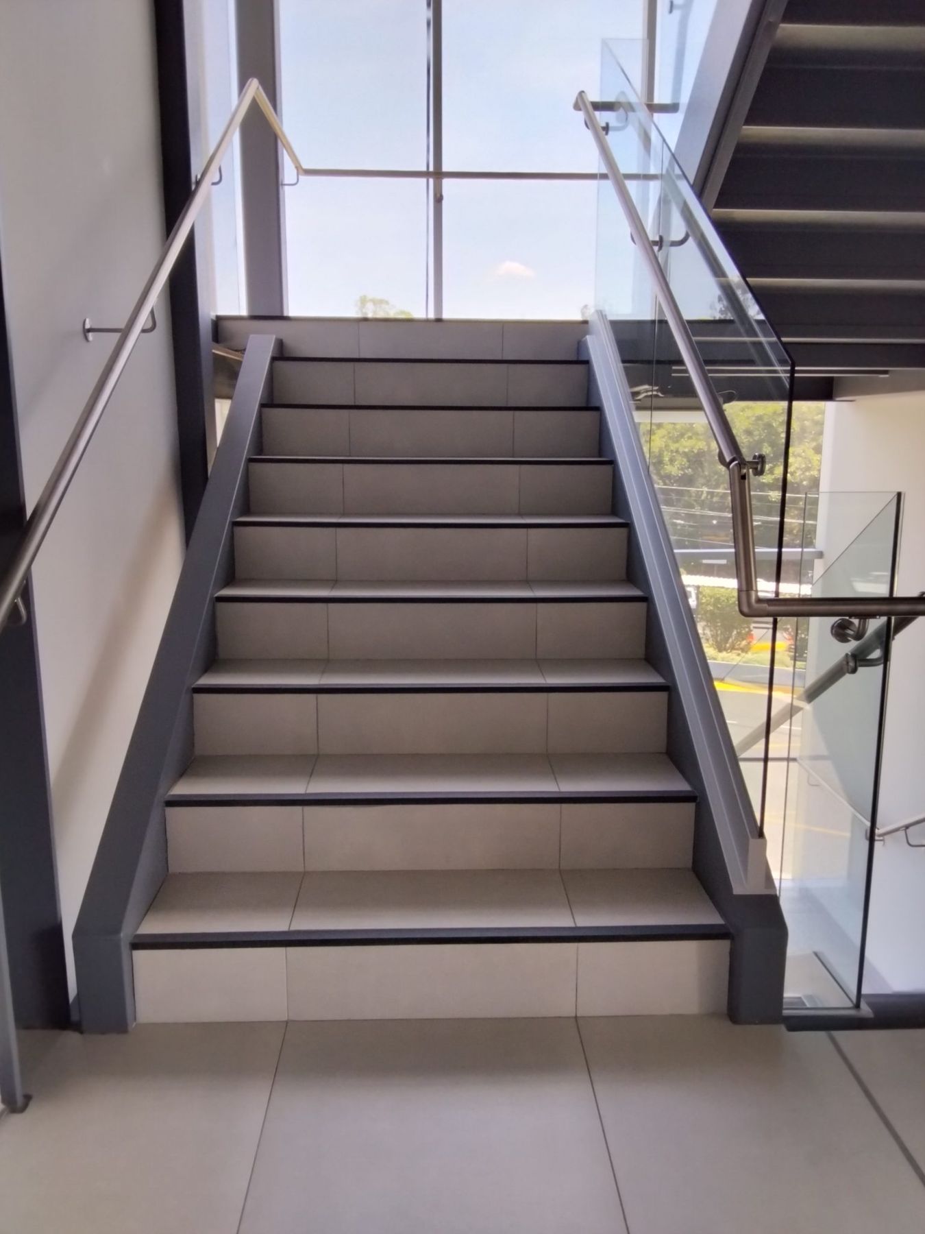 Staircase with a brushed stainless steel hand rail